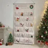 A Christmas advent calendar hanging on a wall next to a decorated Christmas tree. Anteprima dell’immagine prodotto