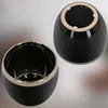 Two black ceramic pots with gold rims, one shown from the inside and the other from the bottom. Náhľad obrázku produktu