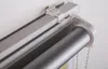 A close-up view of a roller blind mechanism attached to a wall. Produktbild-Vorschau