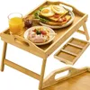 A bamboo breakfast tray with food and drinks. Produktbild-Vorschau