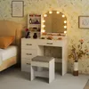 A bedroom scene featuring a white vanity table with a lighted mirror, a stool, and a bed. Voir les images du produit