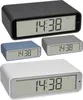A collage of four digital alarm clocks in different colors (black, gray, blue, and white), all displaying the same time. Podgląd zdjęcia produktu