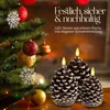 A Christmas tree with ornaments and three pine cone LED candles in front of a fireplace. Produktbild-Vorschau