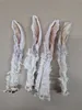 Four dried rabbit ears with fur on a light-colored wooden surface. Produktbild-Vorschau