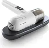 A handheld vacuum cleaner is shown resting on its charging base. Voir les images du produit