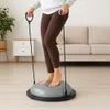 A person is using a balance trainer with resistance bands in a living room. Anteprima dell’immagine prodotto