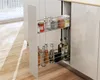 A pull-out kitchen cabinet organizer with two shelves filled with various bottles and jars. Voir les images du produit