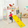 Children playing on a wooden indoor playground structure with a slide, climbing net, and abacus. Podgląd zdjęcia produktu