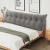 A bed with a large, tufted gray headboard pillow. Produktbild-Vorschau