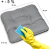 A gray cushion is being cleaned with a blue sponge by a hand wearing a yellow glove. Dimensions are indicated. Produktbild-Vorschau