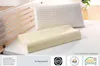 A latex pillow and a standard pillow on a bed. Produktbild-Vorschau