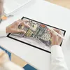 A person is using a digital drawing tablet to create a sketch of a city street. Produktbild-Vorschau
