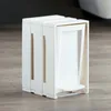 A white trash can with a pedal is shown on a wooden floor. Anteprima dell’immagine prodotto