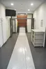 A long hallway with a white runner leading to stairs. Produktbild-Vorschau