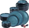 A collection of blue and black ceramic plates and bowls are stacked and arranged on a white background. Produktbild-Vorschau