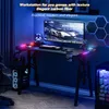 A gaming desk setup with a computer, monitor, and accessories, illuminated by LED lights. Voir les images du produit