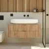 A modern bathroom vanity with a white vessel sink and wooden drawers, set against a tiled wall and wooden slatted wall. Anteprima dell’immagine prodotto