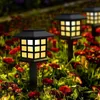 Solar garden lights illuminating a flower bed at dusk. Anteprima dell’immagine prodotto