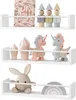 Three shelves displaying children's toys and decorative items. Produktbild-Vorschau