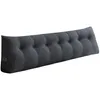 A dark gray, tufted wedge pillow designed to be used as a headboard or backrest. Produktbild-Vorschau
