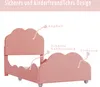 A pink upholstered bed frame with cloud-shaped headboard and footboard, with labels pointing to different parts of the bed. Náhľad obrázku produktu