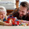A father and child are playing with a LEGO set on the floor. Produktbild-Vorschau