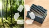 A split image showing a forest on the left and a black plastic object on a wooden surface on the right, with a recycling symbol overlay. Produktbild-Vorschau