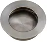 A close-up, top-down view of a circular, recessed drawer pull or handle made of brushed metal. Produktbild-Vorschau