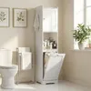 A bathroom scene with a toilet, towel rack, and a tall white cabinet. Voir les images du produit