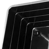 A close-up view of stacked black plastic containers with rounded corners. Anteprima dell’immagine prodotto