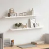 Two white shelves mounted on a white wall, decorated with various items. Voir les images du produit