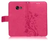 A pink flip case for a smartphone, decorated with an embossed floral and butterfly pattern. Produktbild-Vorschau