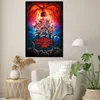 A poster of the TV show Stranger Things is displayed on a wall above a chair and side table. Podgląd zdjęcia produktu