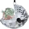 A crystal ornament of a baby character in a pod. Produktbild-Vorschau