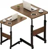 Two adjustable height tables with laptops and cups on them. Produktbild-Vorschau