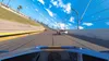 A first-person perspective of a racing game on a track with a blue sky and clouds. Podgląd zdjęcia produktu