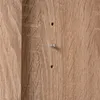 A close-up view of a wooden surface with two small metal screws or bolts inserted into it. Produktbild-Vorschau