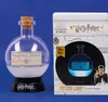A Harry Potter Polyjuice Potion lamp and its packaging are displayed against a blue background. Náhľad obrázku produktu