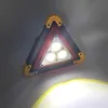 A triangular LED warning light is shown on a light gray background, with a bright yellow light beam emanating from the bottom. Voir les images du produit