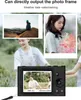 A digital camera is shown in the foreground, with sample photos displayed on its screen and in the background. The background also features people interacting. Podgląd zdjęcia produktu