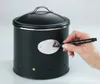 A hand is writing on a label on a black storage container. Anteprima dell’immagine prodotto