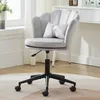 A gray velvet office chair with a scalloped back and a small decorative pillow is shown in a well-lit room. Produktbild-Vorschau