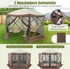 A pop-up gazebo set up in a grassy yard with two chairs and a table inside. Podgląd zdjęcia produktu