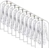 Multiple garment bags with clothes inside, arranged in a diagonal line. Produktbild-Vorschau