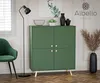 A green cabinet with gold handles is displayed in a room with a green chair, a floor lamp, and decorative items. Podgląd zdjęcia produktu