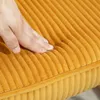 A hand pressing into a yellow corduroy cushion. Náhled obrázku produktu