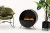 A modern living room setup with a rocking chair, a circular fireplace, and a potted plant. Náhled obrázku produktu