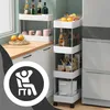 A narrow rolling cart filled with kitchen items like bottles, jars, and boxes, placed next to a kitchen counter and refrigerator. A circular overlay with a person relaxing in a chair is present. Podgląd zdjęcia produktu