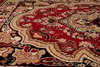 A close-up view of a red and beige patterned rug. Anteprima dell’immagine prodotto