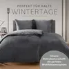 A dark gray duvet cover and pillow set is displayed on a bed, with text overlay suggesting it's perfect for cold winter days. Náhled obrázku produktu